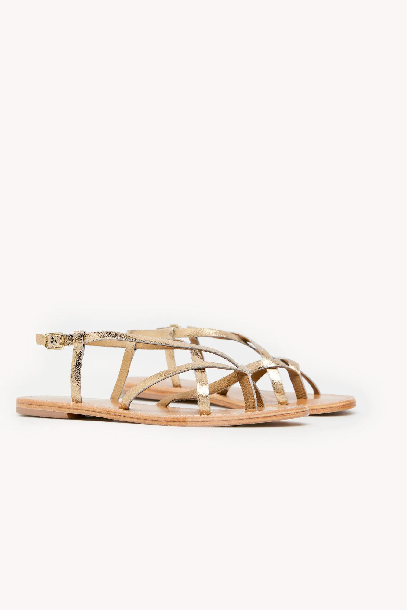Melba. Sandalias planas de piel metalizada